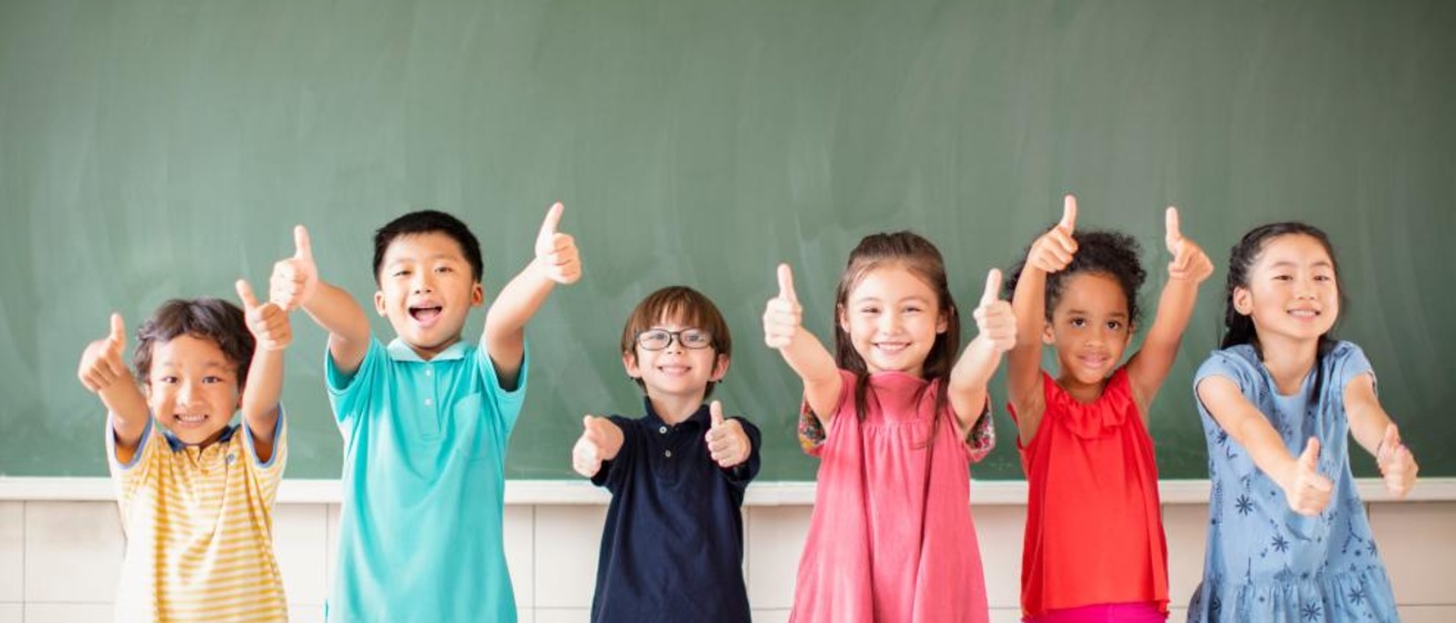 Stock photo of children holding up their thumbs